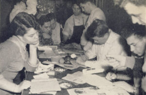 Ticker staff working on paper.