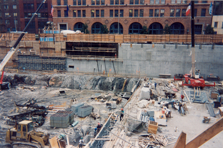Construction workers and equipment in construction site.